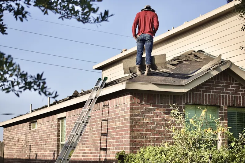 Professional roofer working on a residential roof in River Hill